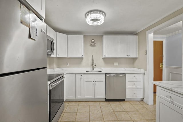 kitchen featuring light tile patterned flooring, sink, white cabinets, and stainless steel appliances