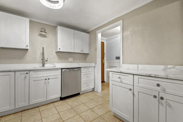 kitchen with sink, white cabinets, stainless steel dishwasher, light tile patterned flooring, and ornamental molding