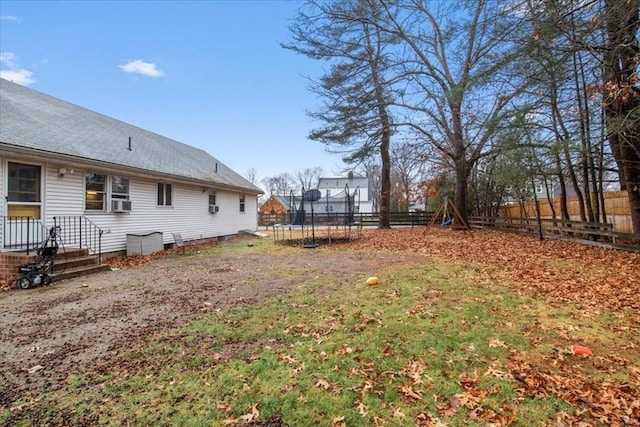 view of yard with a playground and a trampoline