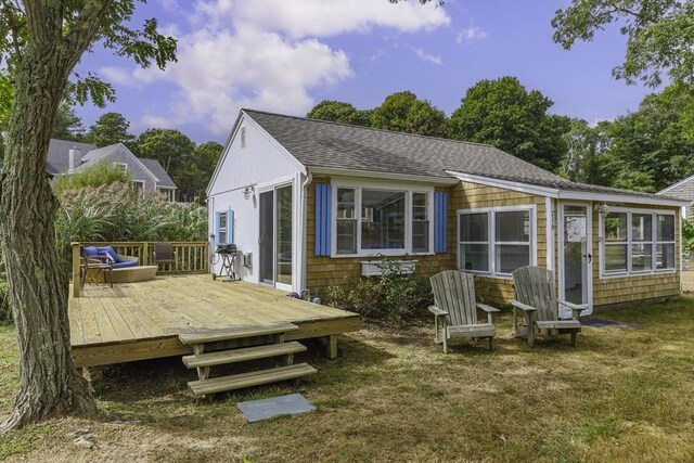 back of property featuring a wooden deck