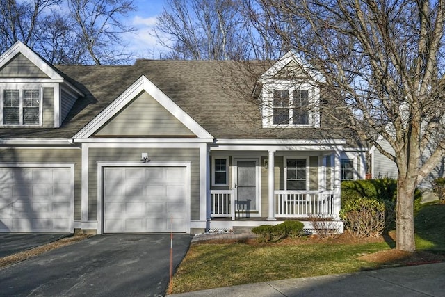 cape cod home with a porch and a garage