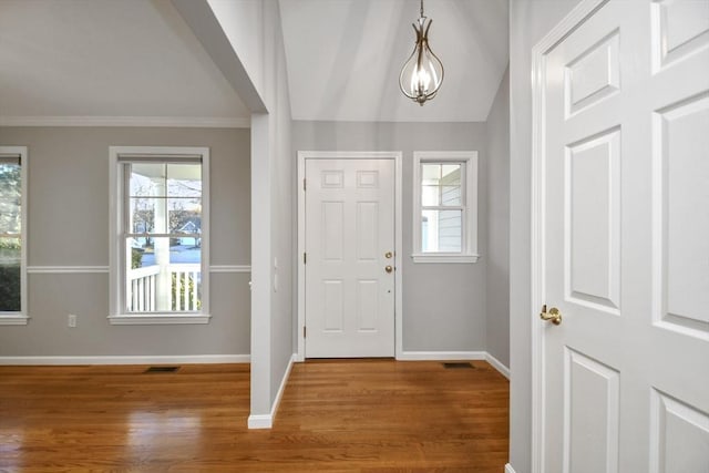 entrance foyer featuring lofted ceiling and hardwood / wood-style floors