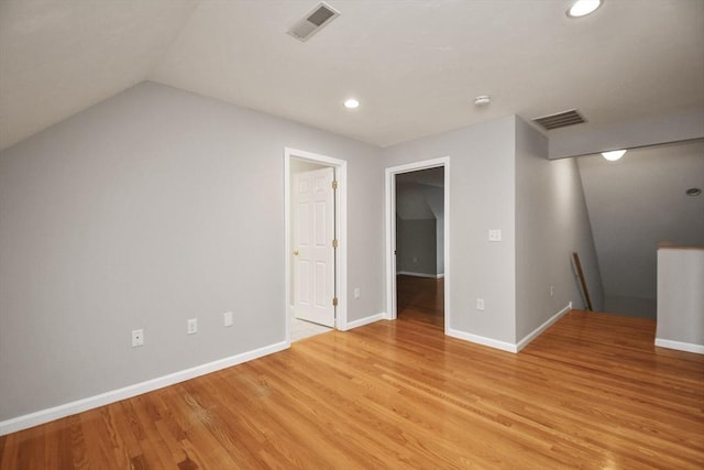 bonus room with light hardwood / wood-style flooring and vaulted ceiling