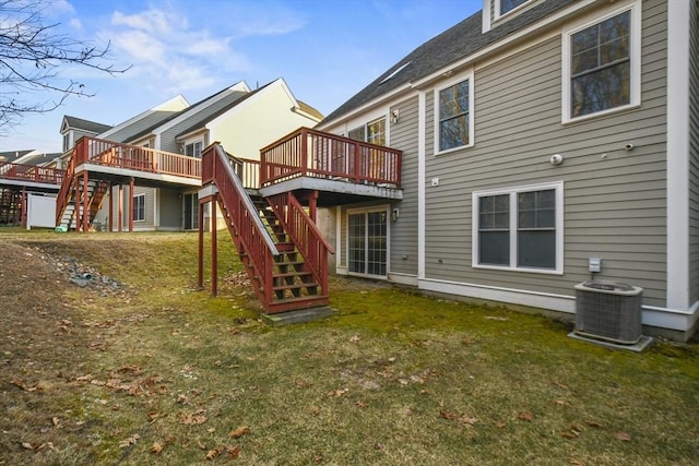 back of property featuring central AC unit, a yard, and a wooden deck