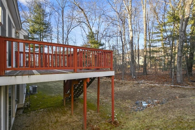 view of yard with central AC unit and a wooden deck