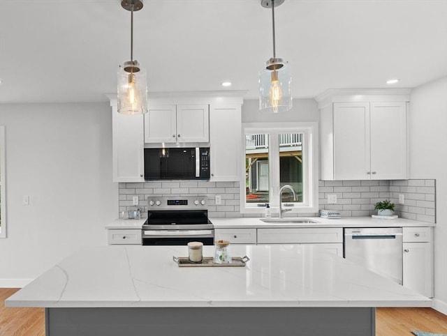 17 Upland Rd, Lynn, MA 01902 - kitchen with stainless steel appliances, light wood finished floors, white cabinetry, and recessed lighting