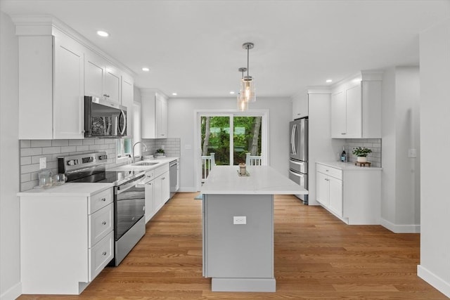 17 Upland Rd, Lynn, MA 01902 - kitchen featuring stainless steel appliances, a kitchen island, backsplash, white cabinets, and recessed lighting