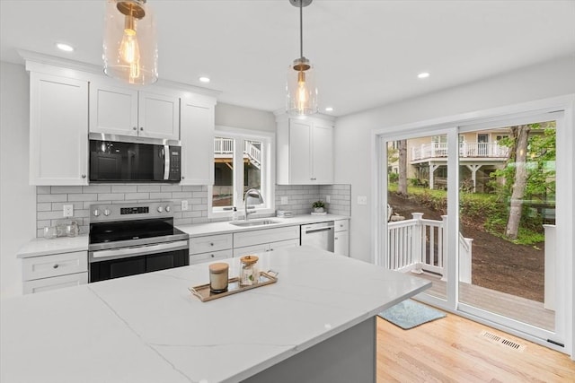 17 Upland Rd, Lynn, MA 01902 - kitchen with appliances with stainless steel finishes, plenty of natural light, light wood-type flooring, decorative backsplash, and recessed lighting