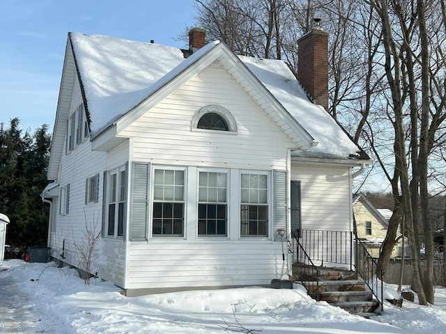 view of front of house featuring a chimney