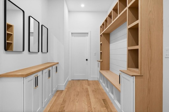 mudroom with recessed lighting, baseboards, and light wood-style floors