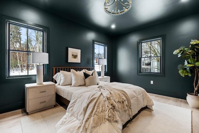 bedroom with baseboards and light wood-style flooring