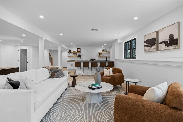 living area with recessed lighting, visible vents, and wet bar