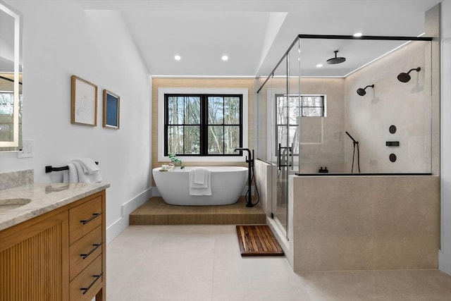 bathroom featuring vanity, a shower stall, a soaking tub, and tile patterned floors