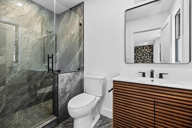 full bath featuring a marble finish shower, baseboards, toilet, marble finish floor, and vanity