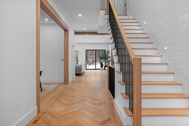 staircase featuring visible vents, recessed lighting, and baseboards