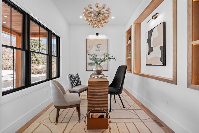 dining space featuring recessed lighting, light wood-style floors, baseboards, and a notable chandelier