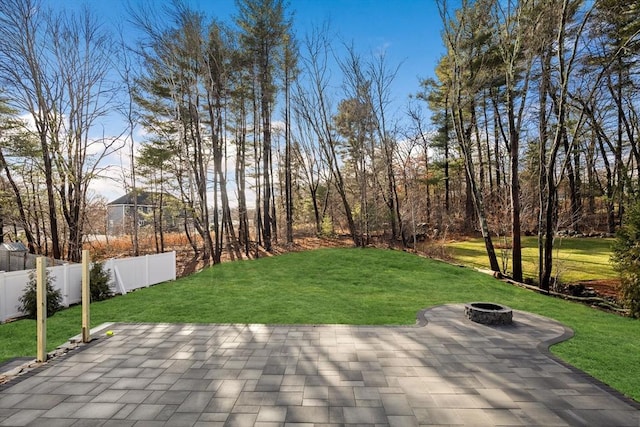 view of patio / terrace with fence and an outdoor fire pit