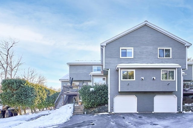 snow covered property featuring a garage