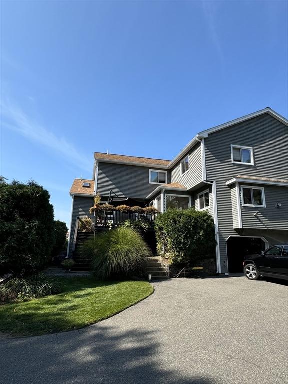 view of front facade with a garage and a wooden deck