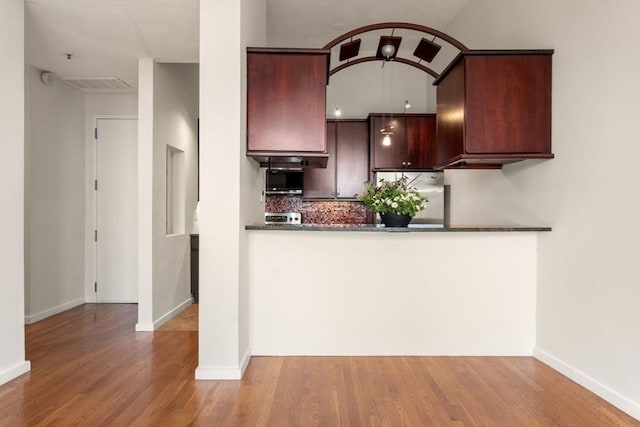 567 Tremont St Unit 20, Boston, MA 02118 - kitchen featuring refrigerator, wood finished floors, backsplash, and a peninsula