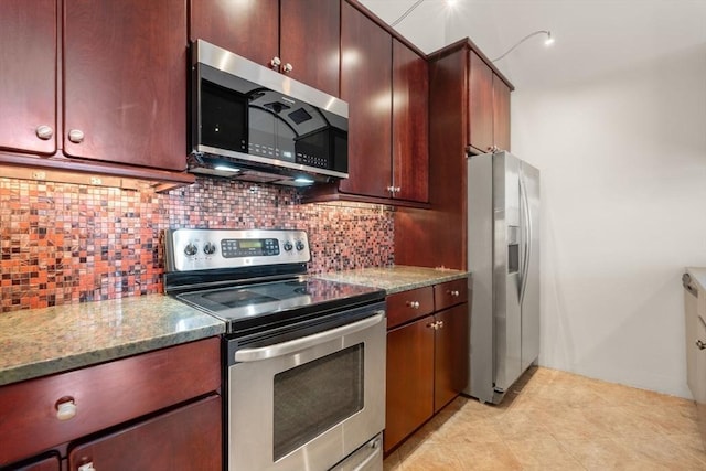 567 Tremont St Unit 20, Boston, MA 02118 - kitchen featuring stainless steel appliances, tasteful backsplash, light stone counters, and light tile patterned floors