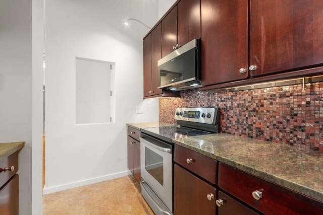 567 Tremont St Unit 20, Boston, MA 02118 - kitchen featuring appliances with stainless steel finishes, decorative backsplash, dark stone counters, and light tile patterned floors