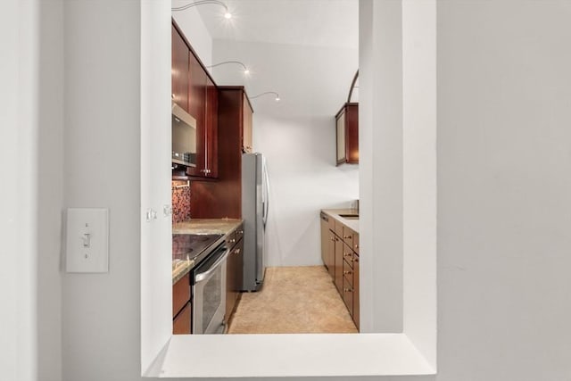 567 Tremont St Unit 20, Boston, MA 02118 - kitchen with stainless steel appliances, light countertops, and dark brown cabinets