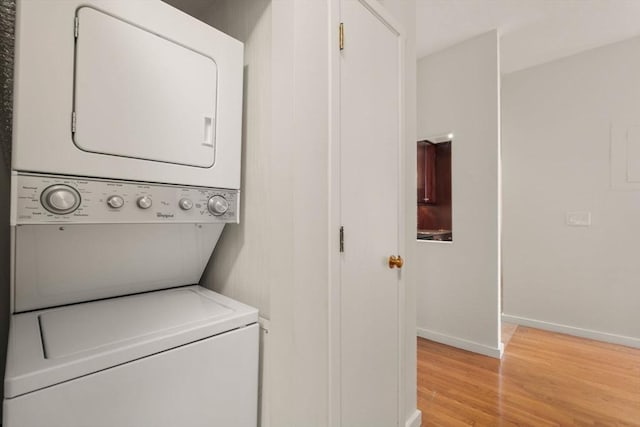 567 Tremont St Unit 20, Boston, MA 02118 - laundry area featuring stacked washer / drying machine and light wood-style flooring