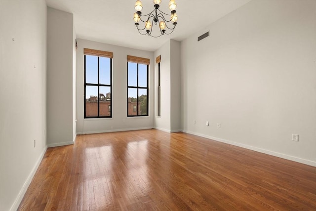 567 Tremont St Unit 20, Boston, MA 02118 - spare room featuring a chandelier and wood finished floors