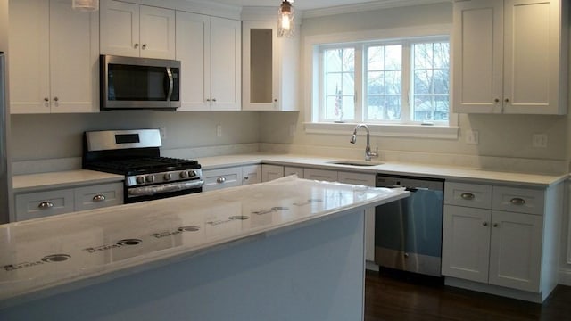 2 Mitchell Ln Unit B, Weymouth, MA 02190 - kitchen with stainless steel appliances, white cabinets, ornamental molding, decorative light fixtures, and dark wood-style floors