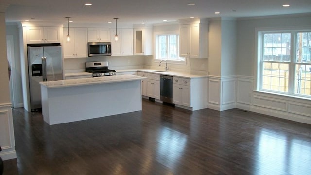 2 Mitchell Ln Unit B, Weymouth, MA 02190 - kitchen with stainless steel appliances, dark wood finished floors, a kitchen island, a decorative wall, and a wainscoted wall