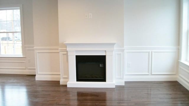2 Mitchell Ln Unit B, Weymouth, MA 02190 - detailed view of a decorative wall, wood finished floors, wainscoting, and a fireplace with raised hearth