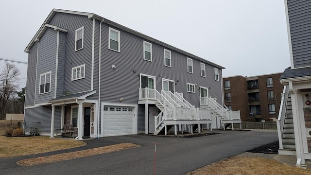 2 Mitchell Ln Unit B, Weymouth, MA 02190 - view of building exterior featuring stairs, an attached garage, and asphalt driveway