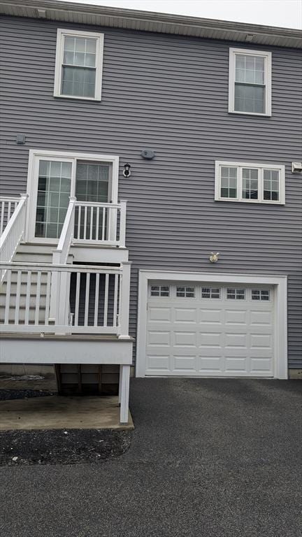 2 Mitchell Ln Unit B, Weymouth, MA 02190 - rear view of property featuring asphalt driveway and an attached garage