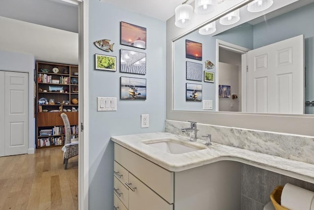 bathroom with hardwood / wood-style floors and vanity