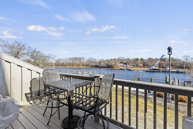 wooden terrace featuring a water view