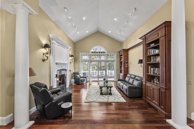 interior space with vaulted ceiling, dark wood-type flooring, and ornate columns