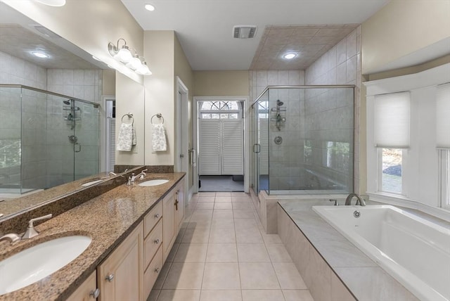 bathroom with a wealth of natural light, vanity, separate shower and tub, and tile patterned flooring