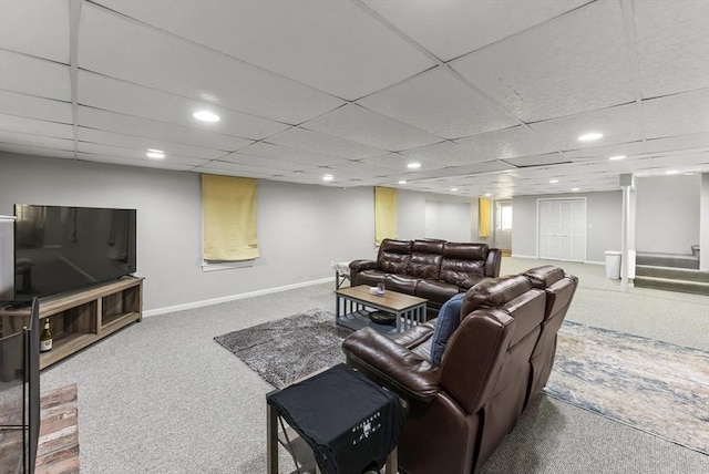 living room with a paneled ceiling and carpet flooring