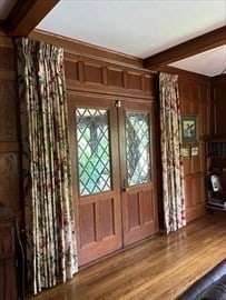 interior space featuring hardwood / wood-style floors, wooden walls, and beam ceiling