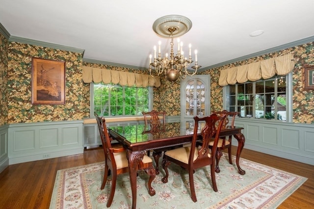 dining room featuring a healthy amount of sunlight, a notable chandelier, and hardwood / wood-style flooring