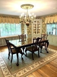 dining space with wood-type flooring and a chandelier