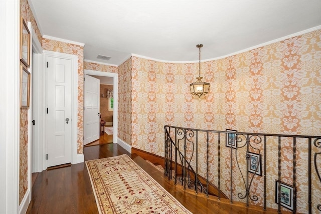 corridor featuring ornamental molding and dark hardwood / wood-style floors