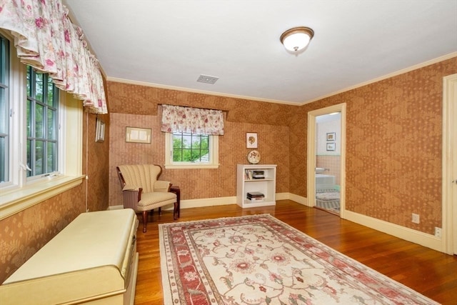 sitting room featuring hardwood / wood-style flooring and crown molding