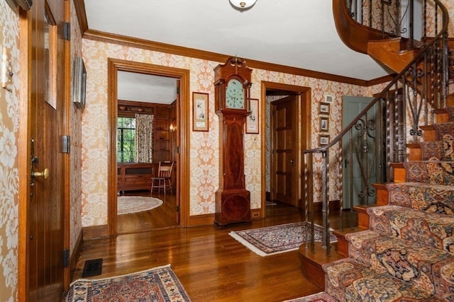 entryway featuring hardwood / wood-style flooring and ornamental molding