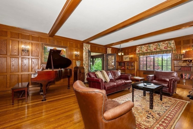 living room with hardwood / wood-style flooring, beam ceiling, and wooden walls