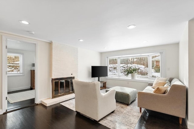 living room featuring hardwood / wood-style flooring and a fireplace