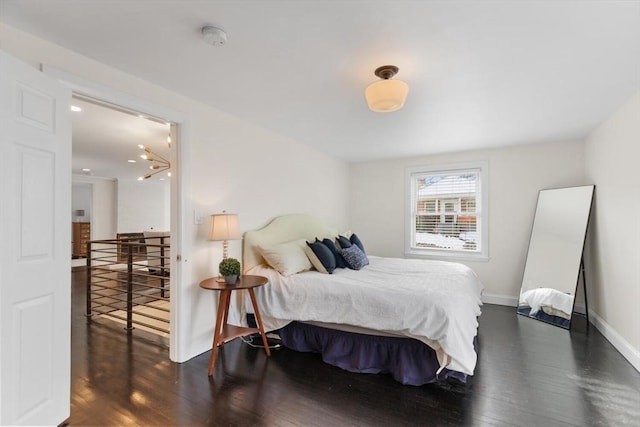 bedroom with dark hardwood / wood-style flooring