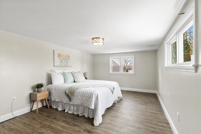 bedroom with dark wood-type flooring