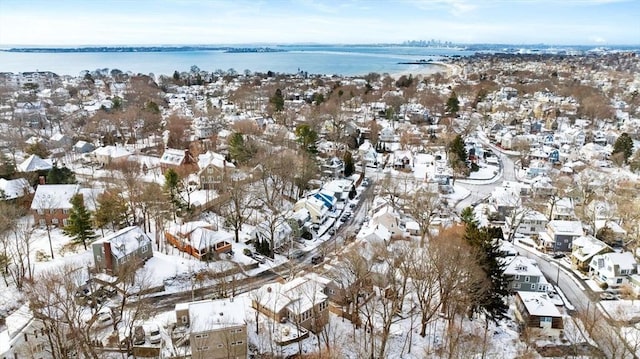 snowy aerial view with a water view